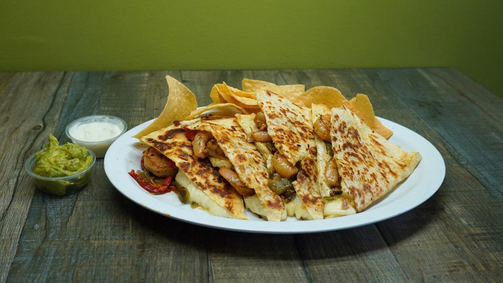 Shrimp Quesadilla · 13” flour tortilla grilled marinated shrimp, jack- cheese, caramelized onions-poblano chilies, cut into 4 pieces served with a side of chips, sour cream & guacamole.