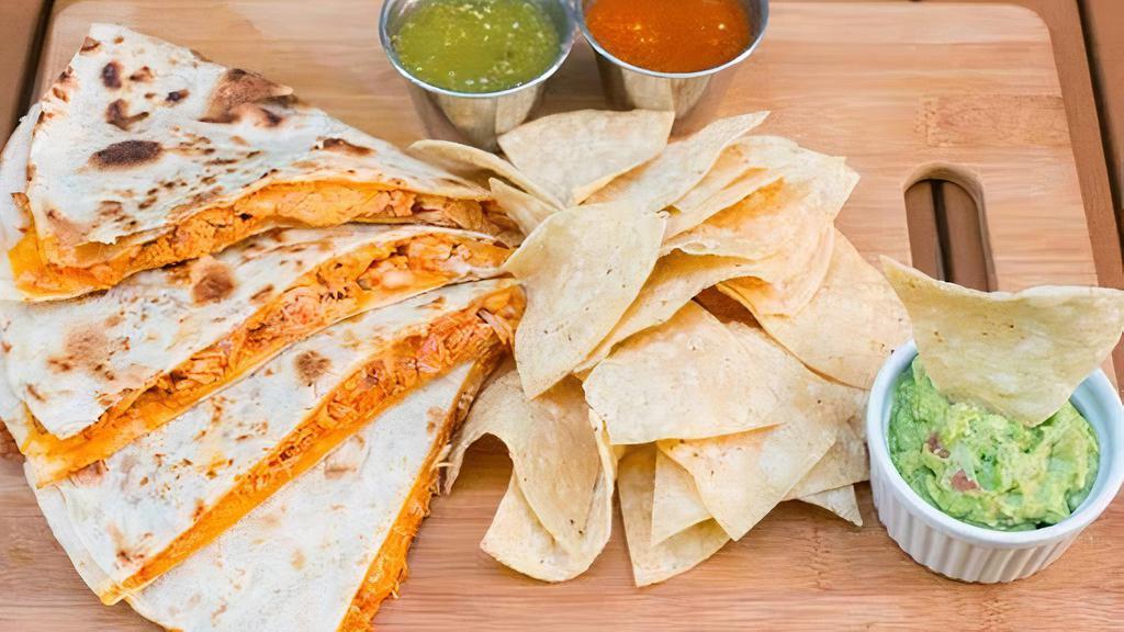 Chipotle Chicken Quesadilla · 13” flour tortilla shredded chicken in a red sauce, jack cheese, caramelized onions-poblano chilies, cut into 4 pieces served with a side of chips, sour cream & guacamole.