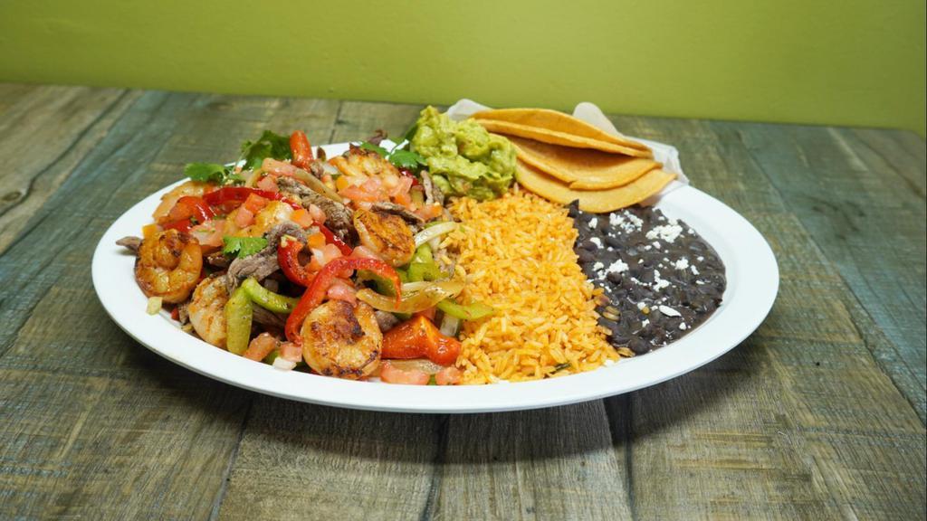 New! Steak N’ Shrimp Fajitas · Half pound of angus steak and marinated shrimp grilled with fresh bell peppers, onion and pico de gallo, served with a side of chips, guacamole, rice, choice of pinto or black beans and choice of corn or flour tortillas.