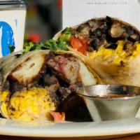Grande Breakfast Burrito · From Orphan Breakfast House! Scrambled eggs, potatoes, black beans, and bacon wrapped in a h...