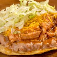 Chicken Tostada · Refried beans, shredded chicken, cheese, and lettuce.