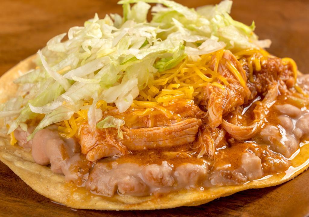 Chicken Tostada · Refried beans, shredded chicken, cheese, and lettuce.