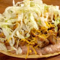 Carnitas Tostada · Beans, lettuce and cheese.