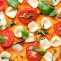 Vegan Margherita Pizza · Vegan mozzarella, tomato, basil, and garlic.
