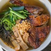 Duck Ramen · Simmered duck broth, roasted duck, egg noodles, bok choy, green onions, bamboo shoots. Garni...