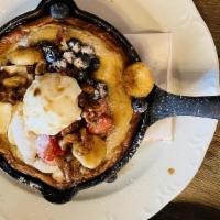 Charm Dutch Baby · Fluffy baked pancake served in a skillet fresh fruit, and whipped cream