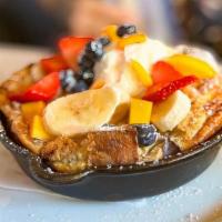 Banana Foster Bourbon Dutch Baby · Caramelized banana's, powdered sugar and fresh whipped