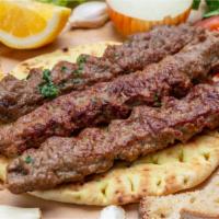 Lamb Boti Kabab · Mouthwatering boneless lamb meat marinated and roasted on a skewer over a bed of red hot cha...