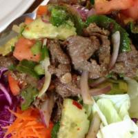 The Beef Salad · Grilled filet mignon(8oz) tossed with chili-pepper lime sauce, tomato, mixed onions, shredde...