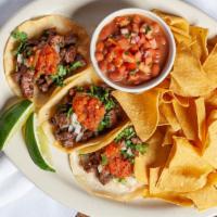 Carne Asada Tacos · Not from any street you've been to! These three mini tacos have asada, onions and cilantro, ...