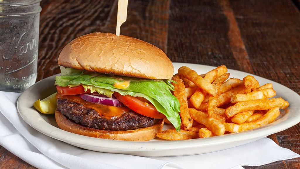 Traditional Burger · Served with cheddar cheese, lettuce, onion, tomato and our special house sauce.
