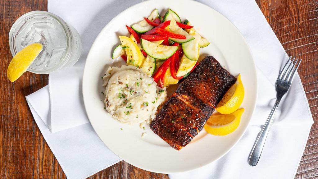 Blackened Salmon · Atlantic salmon filet, grilled with blackening seasoning, brushed with garlic butter and served with your choice of two sides.
