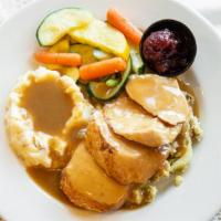 Roasted Turkey Dinner · Hand-carved roasted turkey served over our apple-sage stuffing and topped with house-made gi...