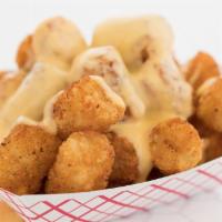 Cheese Tots · Tots covered in house cheese 