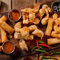 Combo Platter · An assortment of two egg rolls, two butterfly shrimp, two crab Rangoon and two fried dumplin...