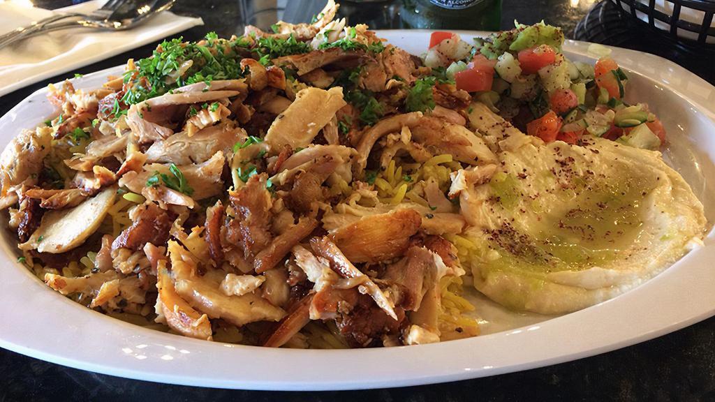 Chicken Shawarma Plate · 1/2lb marinated chicken shaved off the spit.  (the plate comes with rice, Arabic salad, humas and 1 PC of pita bread).