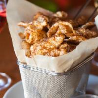 Salsa Verde & Chicharrones · House made charred tomatillo salsa verde with spiced crispy pork rinds.