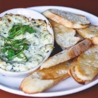 Spinach Artichoke Dip · parmesan crusted served with crostini’s for dipping