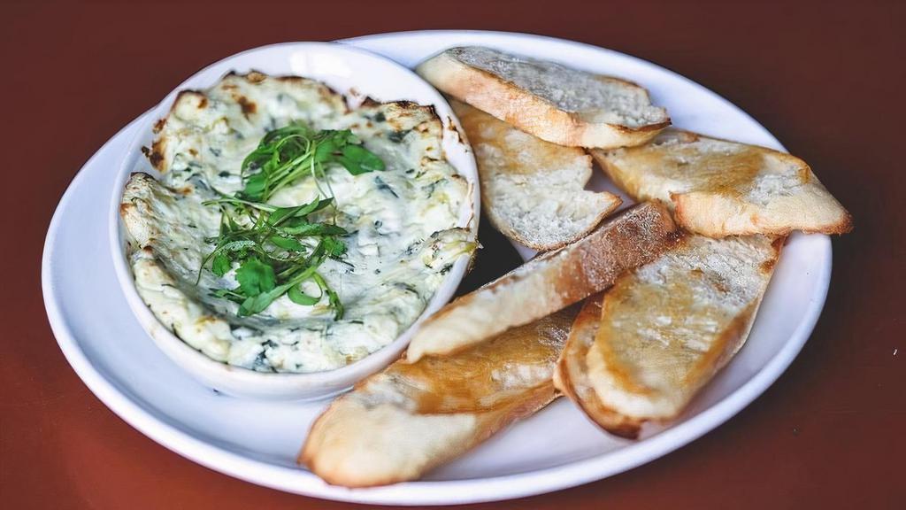 Spinach Artichoke Dip · parmesan crusted served with crostini’s for dipping