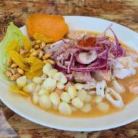 Ceviche Mixto · Fresh fish, calamari, shrimp and marinated in lime juice, served with lettuce, yams, fried c...