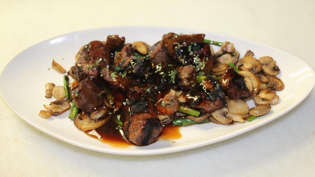 Grilled Steak Bites · Grilled to order, marinated sirloin steak on top of a bed of sautéed mushrooms and asparagus, drizzled with a teriyaki sauce