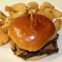 Smoked Brisket Bbq Sandwich · Smoked brisket, house BBQ, caramelized onions, Monterey jack cheese, & sweet slaw. Served on...
