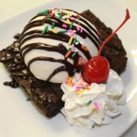 Homemade Brownie À La Mode · Warm, gooey, moist brownie, topped with vanilla ice cream, chocolate syrup, whipped cream, s...