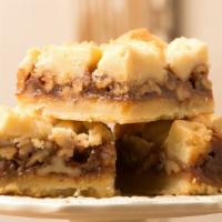 Caramel Bar · House-made caramel, toasted walnuts, atop a shortbread crust with buttery shortbread crumbles.