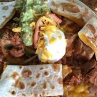 Nachos Supreme · Tortilla chips topped with refried beans, cheddar cheese, guacamole, sour cream, mini quesad...
