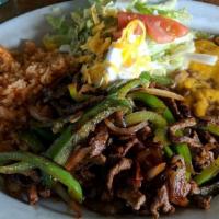Fajitas · Thin slices of top sirloin or chicken breast marinated and sautéed with bell peppers, onions...