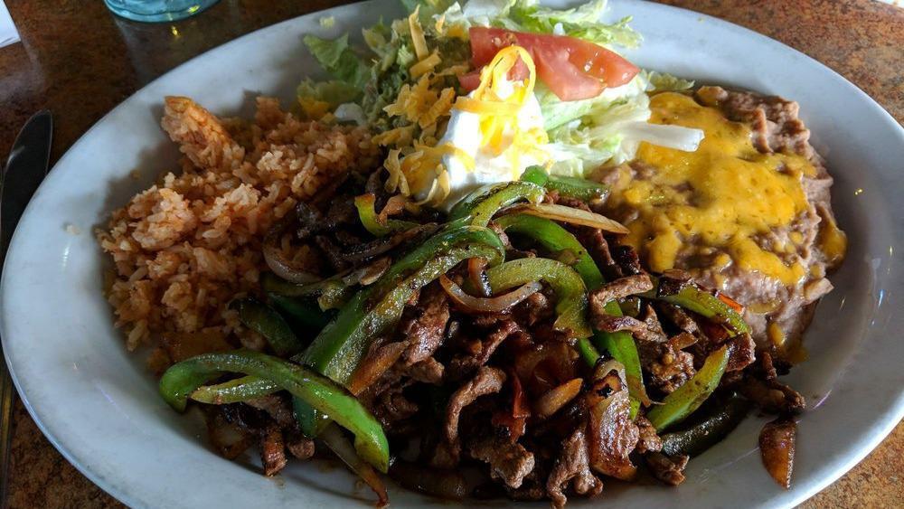 Fajitas · Thin slices of top sirloin or chicken breast marinated and sautéed with bell peppers, onions, and tomatoes.