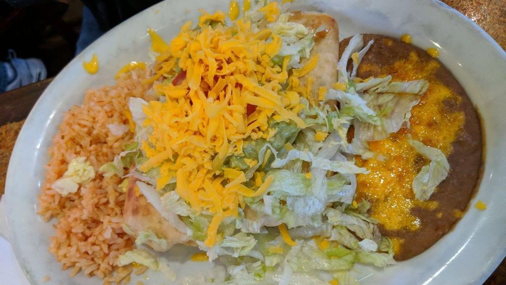 Chimichangas · Two deep fried flour tortillas filled with your choice of beef, chicken, or pork topped with lettuce, cheese tomatoes, sour cream, and guacamole.