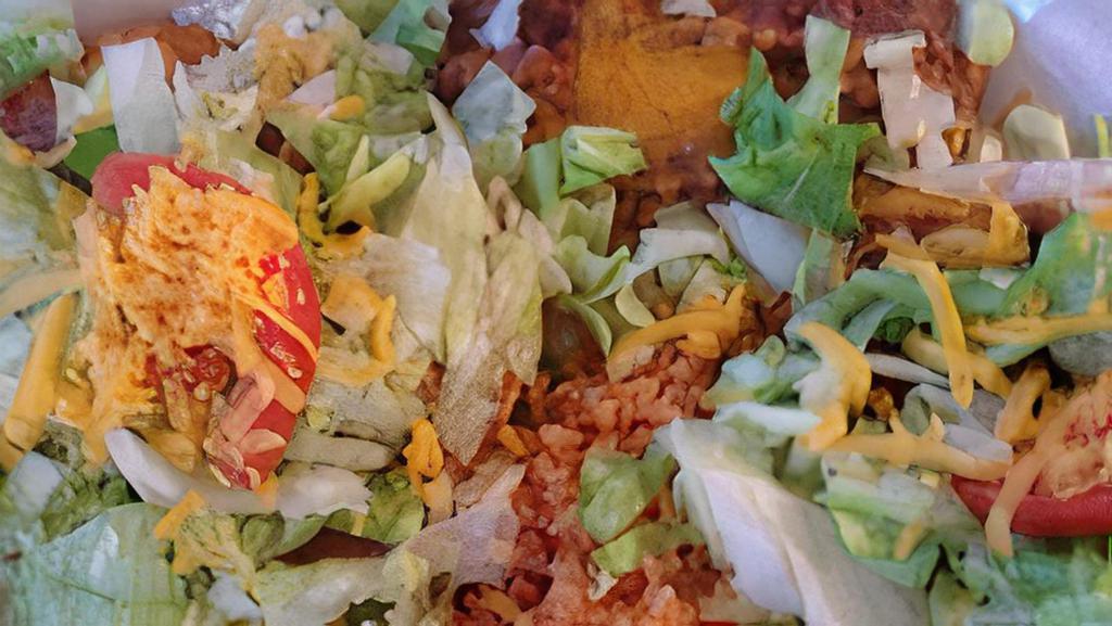 Tostada · One deep fried corn tortilla with beans and your choice of guacamole, beef, chicken or pork.  Topped with lettuce, cheese, and tomato.