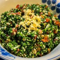 Tabouleh Salad · Our specialty Salad. Finely Chopped fresh parsley, bulgur wheat, tomatoes, and onions and mi...