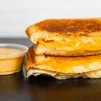 Three Cheese Grilled Cheese · Cheddar, Swiss, and Parmesan cheeses melted between buttery, toasted sourdough bread. Served...