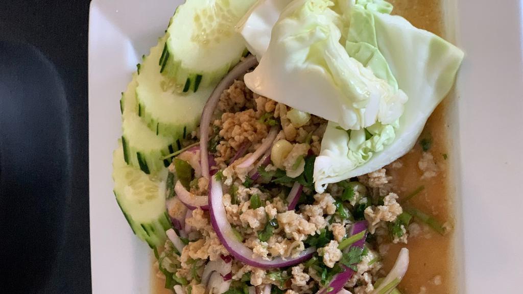 Larb · Your choice of minced chicken/pork mixed with red onion, green onion, mint leaves, cilantro dried red chili, roasted ground rice, and lime juice.