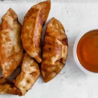 T4 Gyoza Potstickers · Chicken and vegetables potstickers fried to golden crisp served with gyoza sauce.  6 per order