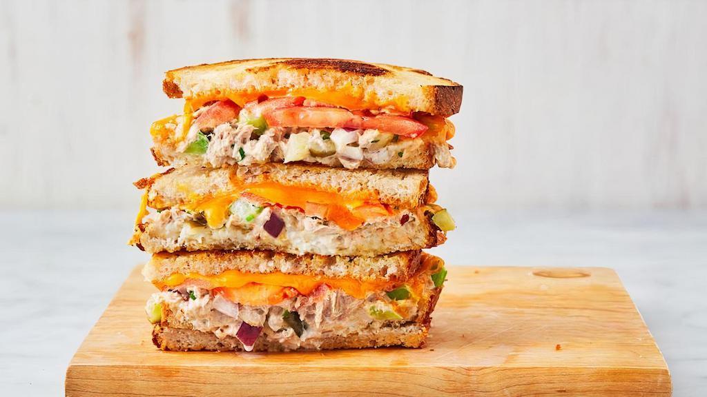 Tuna Melt · Melted cheddar, house made tuna salad, and sliced tomato between two slices of buttery grilled bread.