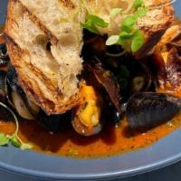 Steamed Black Mussels · Choice of white wine and garlic broth or rustic tomato broth.  Served with shallots and gril...