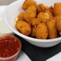 Wisconsin Cheese Curds · White cheddar cheese curds, breaded and fried served with marinara sauce.