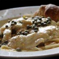 Chicken Piccata · Sautéed chicken breast in a lemon caper cream sauce over fettuccine and a sprinkle of parsley.