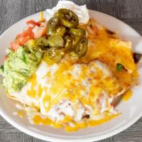 Nachos · Homemade tortilla chips with refried beans, melted jack and cheddar cheese, guacamole, sour ...