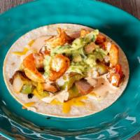 Ensenada Shrimp Taco · A corn tortilla with grilled shrimp, sautéed veggies, melted cheese, baja sauce, cilantro an...