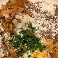 Chilaquiles Spicy Red · Crispy homemade tortilla chips tossed in norma’s salsa and two eggs. Topped with cilantro, s...