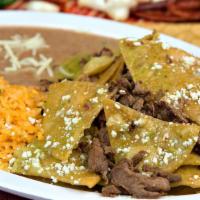 Chilaquiles Con Carne · Delicious Mexican chilaquiles with red or green salsa topped with your choice of meat.