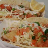Grilled Fish Taco · Corn tortilla taco with fish fillet, cabbage, pico de gallo, special house cream and lemon (...