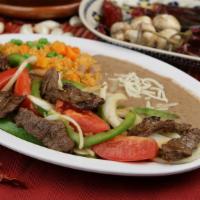 Steak Fajitas · Grilled beef strips with sautéed bell peppers, cilantro, and onions. Served with rice, beans...