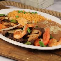 Steak, Chicken & Shrimp Fajitas · Grilled beef strips, chicken and shrimp with sautéed bell peppers, cilantro, and onions. Ser...