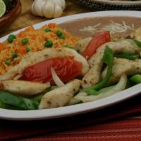 Fish Fajitas · Grilled fish with sautéed bell peppers, cilantro, and onions. Served with rice, beans, and t...