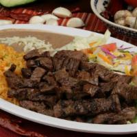 Carne Asada Plate · Delicious strips of broiled ranchera meat with rice, beans, salad, and tortillas.